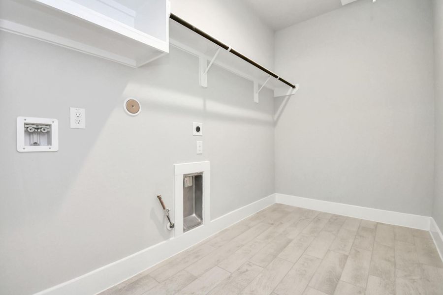 A perfect blend of functionality and comfort. Capture the essence of easy living with a first-floor laundry room, thoughtfully equipped with shelving for effortless organization. Both electric and gas connections available. A perfect blend of functionality and comfort. Capture the essence of easy living with a first-floor laundry room, thoughtfully equipped with shelving for effortless organization. Both electric and gas connections available.