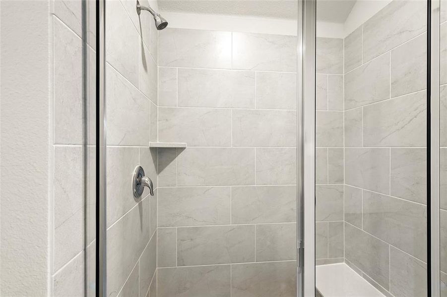 Bathroom featuring a shower stall Bathroom featuring a shower stall