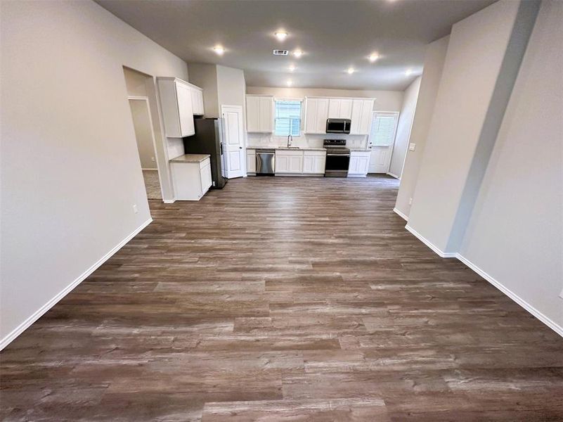 Another view of your living room featuring vaulted ceilings & entertainment niche!