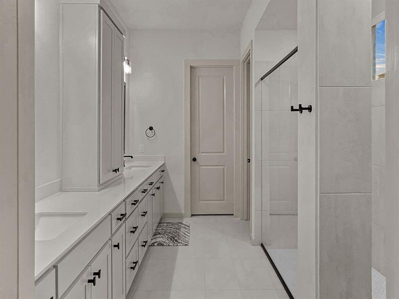 Master Bathroom with vanity, tiled shower, and tile patterned floors