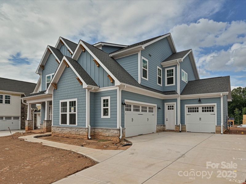 Front exterior of a new home in Coventry Glen, Huntersville, NC, highlighting curb appeal (Image 2). Front exterior of a new home in Coventry Glen, Huntersville, NC, highlighting curb appeal (Image 2).
