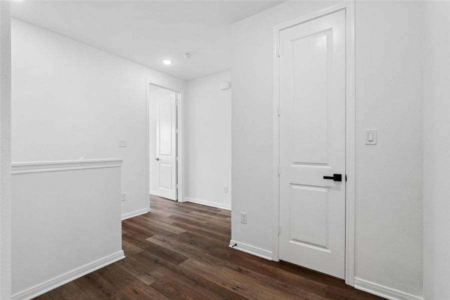 Functional upstairs design with easy access to bedrooms, bathrooms, and laundry room.