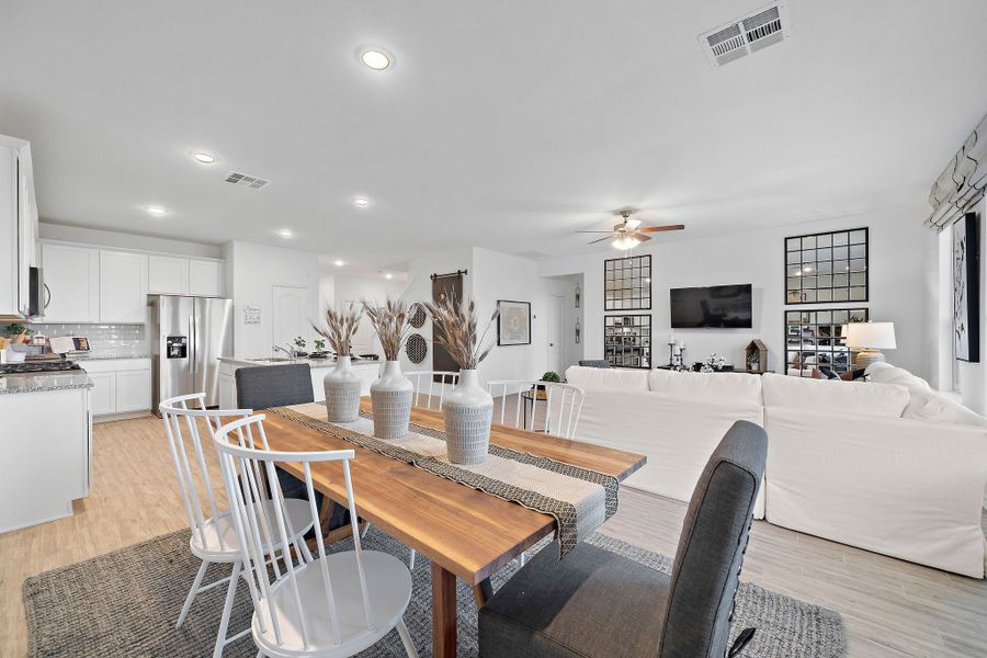 A large living room with a dining table and couches. A large living room with a dining table and couches.