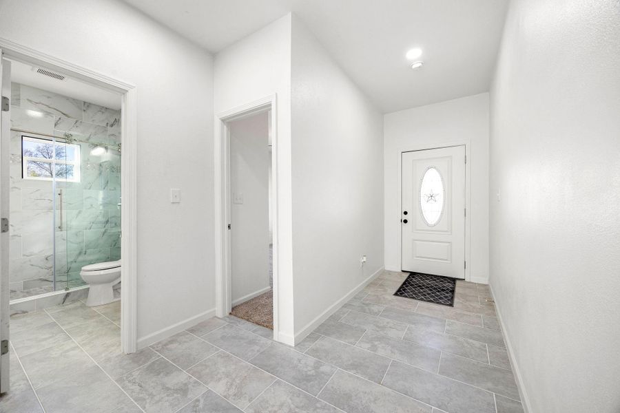 Step into a bright, welcoming entrance with elegant tile flooring and a sleek, modern design. Step into a bright, welcoming entrance with elegant tile flooring and a sleek, modern design.