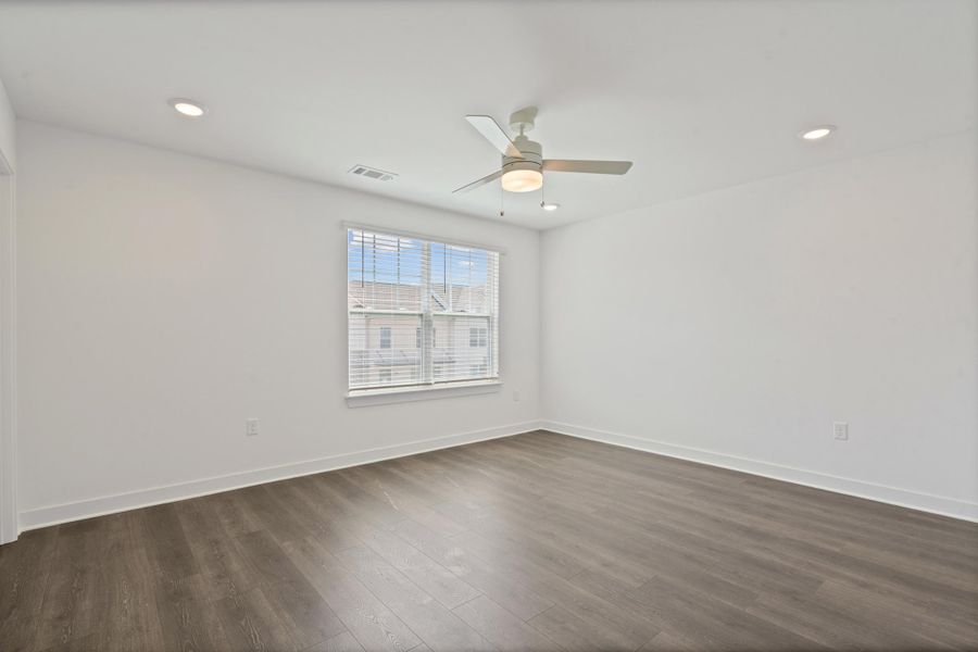 Wood-finish flooring, recessed lighting, ceiling fan with integrated light, and window with blinds