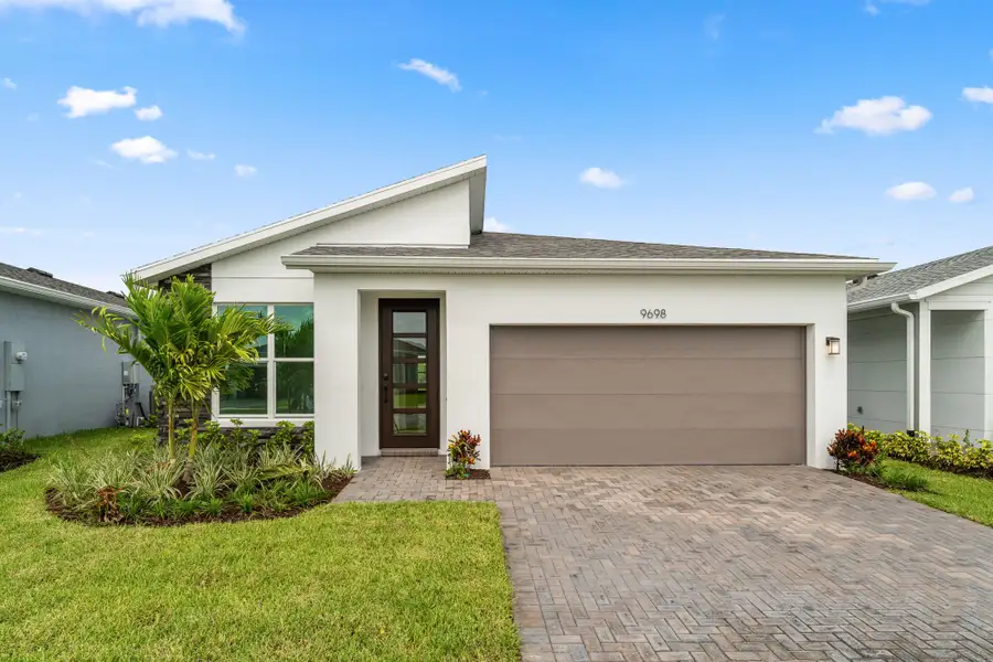 Front exterior of a new home in Tradition - Kenley, Port St. Lucie, FL, highlighting curb appeal (Image 1).