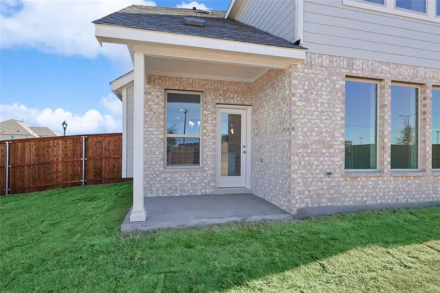 View of exterior entry with a patio and brick siding View of exterior entry with a patio and brick siding