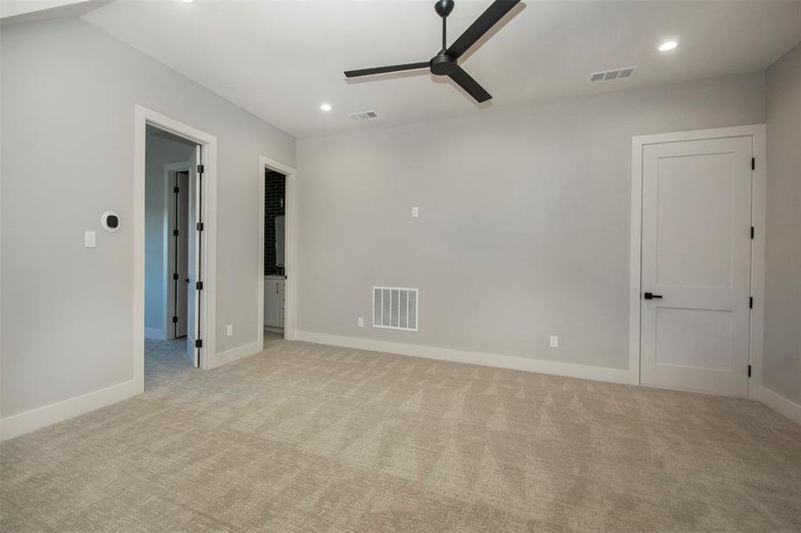 Spare room featuring ceiling fan and light colored carpet