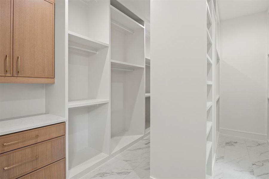 Spacious closet with light marble finish flooring Spacious closet with light marble finish flooring