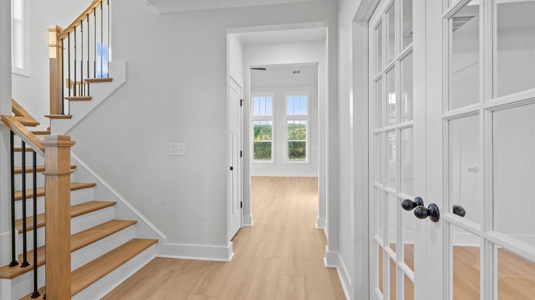 Exceptional foyer with warm hardwood flooring and refined finishes throughout