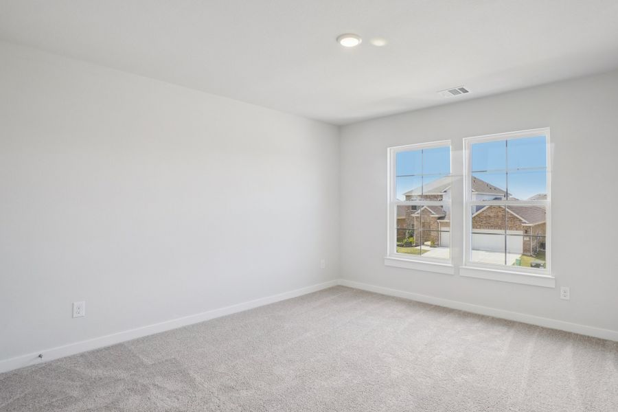 A room with a window and a white wall with a view of a city.