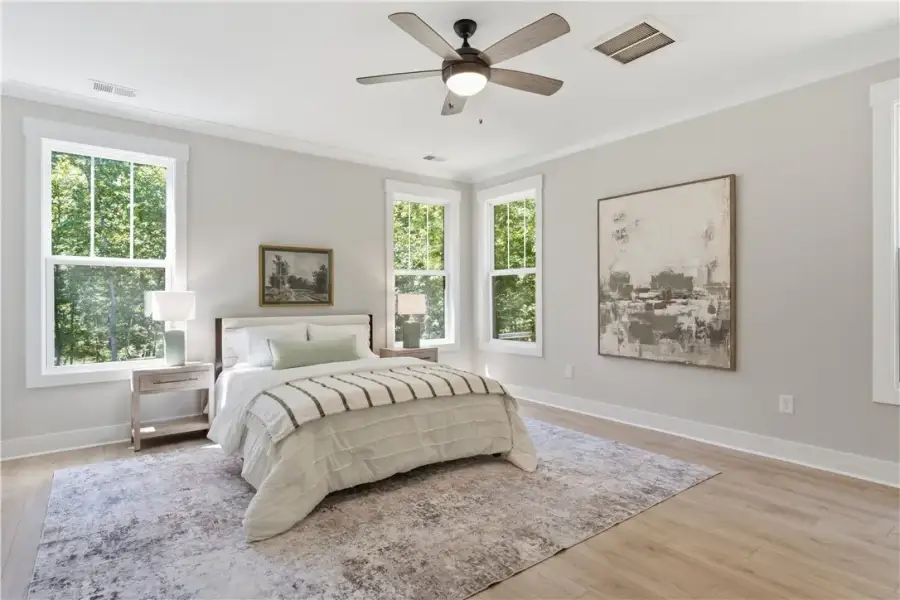 Crown molding and wide-plank wood flooring enrich