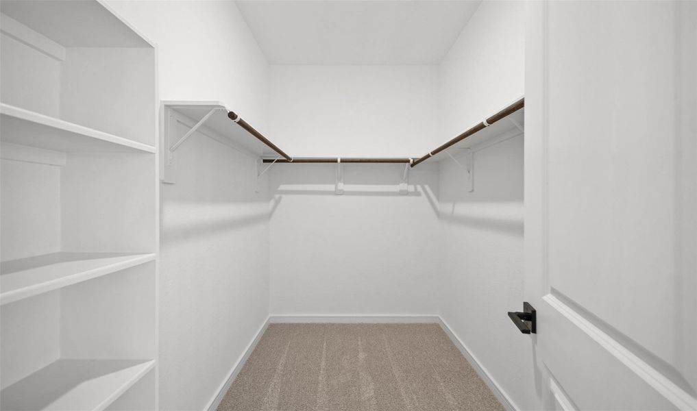 Walk-in closet in the primary suite (*Photo not of actual home and used for illustration purposes only.) Walk-in closet in the primary suite (*Photo not of actual home and used for illustration purposes only.)