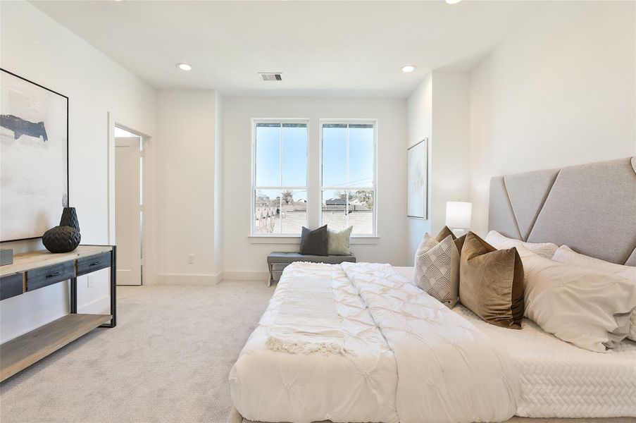 Primary suite complemented by windows that surround the space. Large walk in closet to the left with windows as well to let in natural light. Primary suite complemented by windows that surround the space. Large walk in closet to the left with windows as well to let in natural light.