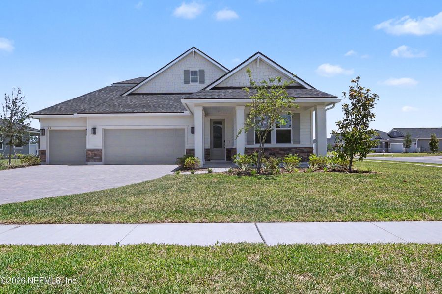 Front exterior of a new home in Brookestone, St. Augustine, FL, highlighting curb appeal (Image 1). Front exterior of a new home in Brookestone, St. Augustine, FL, highlighting curb appeal (Image 1).