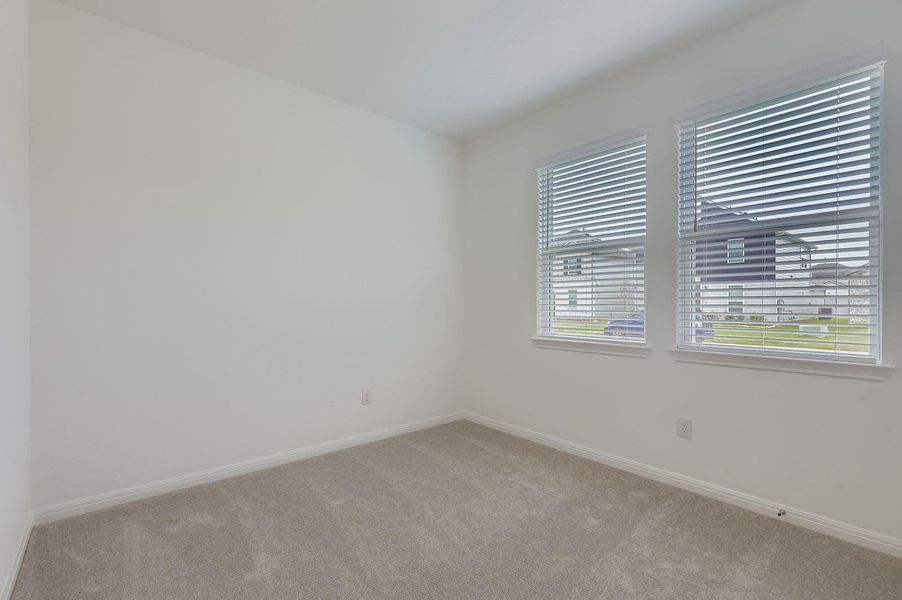 Carpeted empty room featuring baseboards Carpeted empty room featuring baseboards