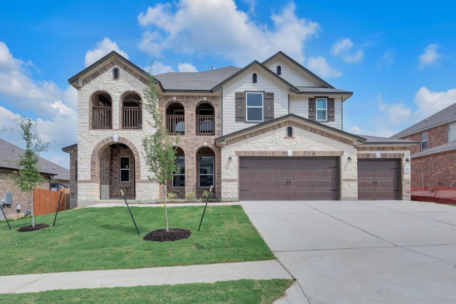 Front exterior of a new home in Salerno - Hallmark Collection, Round Rock, TX, highlighting curb appeal (Image 2). Front exterior of a new home in Salerno - Hallmark Collection, Round Rock, TX, highlighting curb appeal (Image 2).