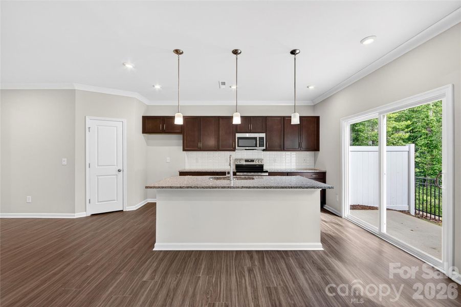 Kitchen with brown cabinets and Caledonia Granite countertops Kitchen with brown cabinets and Caledonia Granite countertops