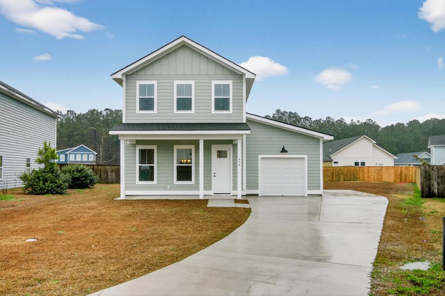 Front exterior of a new home in , Huger, SC, highlighting curb appeal (Image 1). Front exterior of a new home in , Huger, SC, highlighting curb appeal (Image 1).