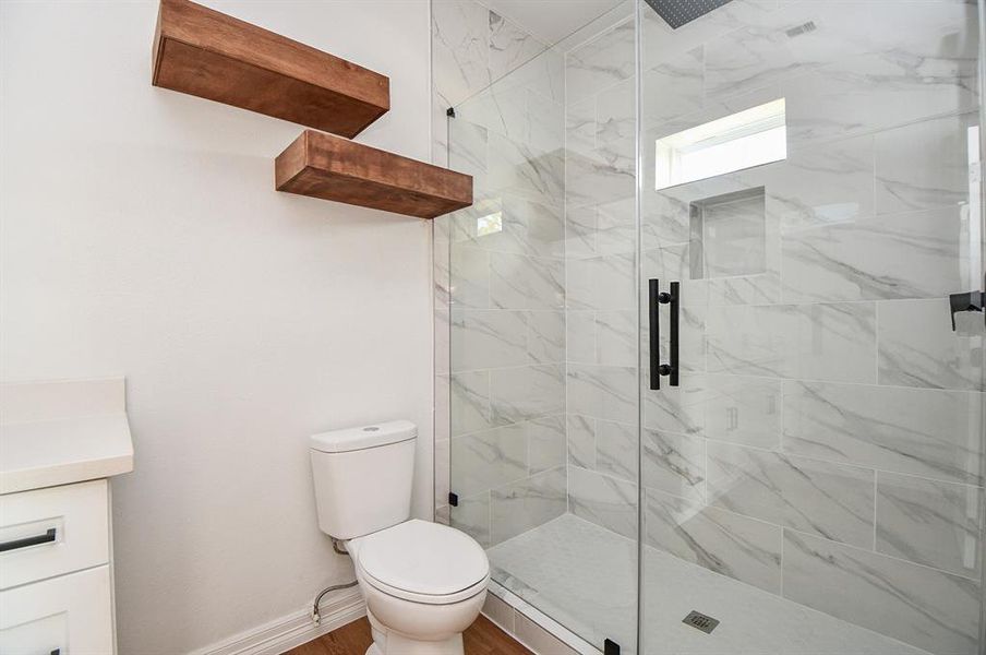 Step into your spacious walk-in shower, complete with a sleek glass door and gorgeous marble tiles! This welcoming space is designed for both comfort and style, creating the perfect little retreat for unwinding and relaxing.