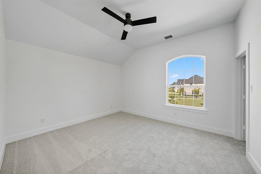 Bonus room featuring lofted ceiling, light colored carpet, and ceiling fan