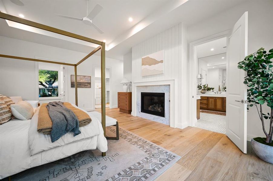 Bedroom featuring connected bathroom, light hardwood / wood-style floors, and ceiling fan