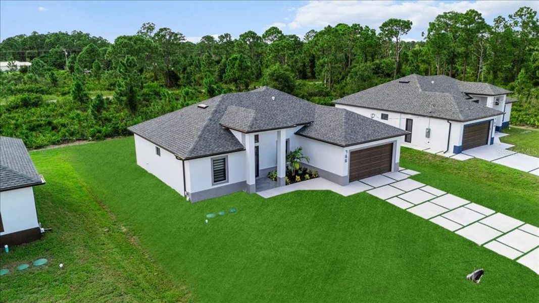 Front exterior of a new home in , Lehigh Acres, FL, highlighting curb appeal (Image 25).
