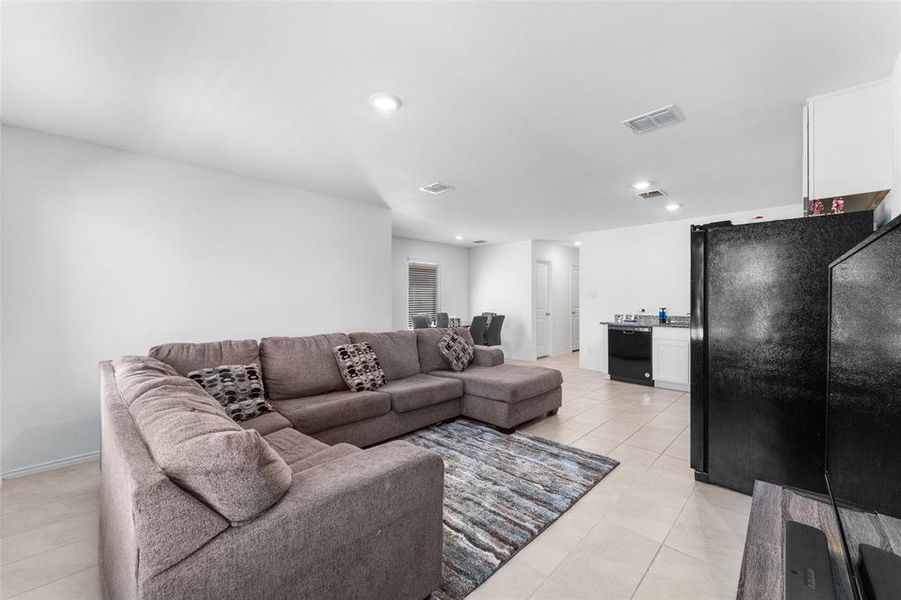 Living area featuring light tile patterned flooring and recessed lighting Living area featuring light tile patterned flooring and recessed lighting