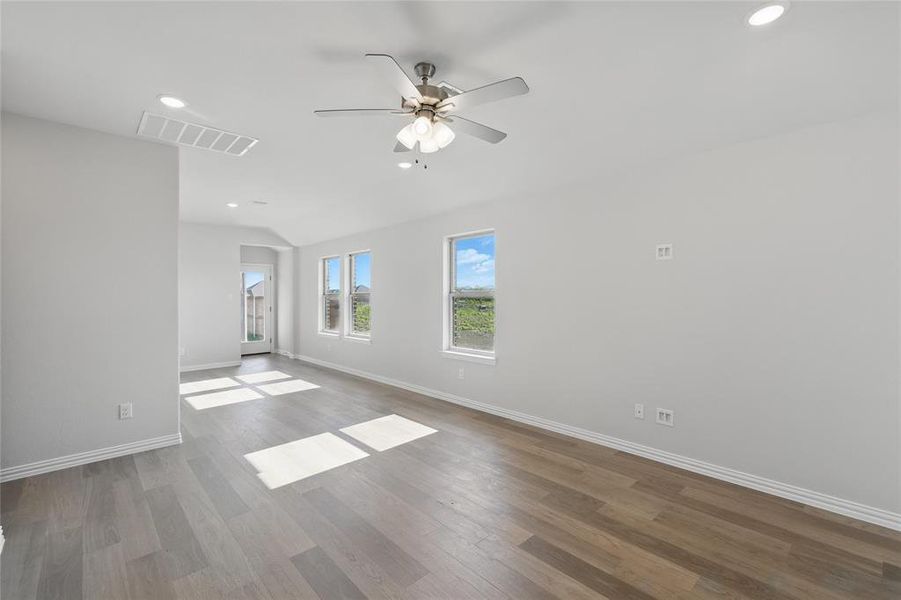 Spare room with recessed lighting, a ceiling fan, wood finished floors, and vaulted ceiling Spare room with recessed lighting, a ceiling fan, wood finished floors, and vaulted ceiling