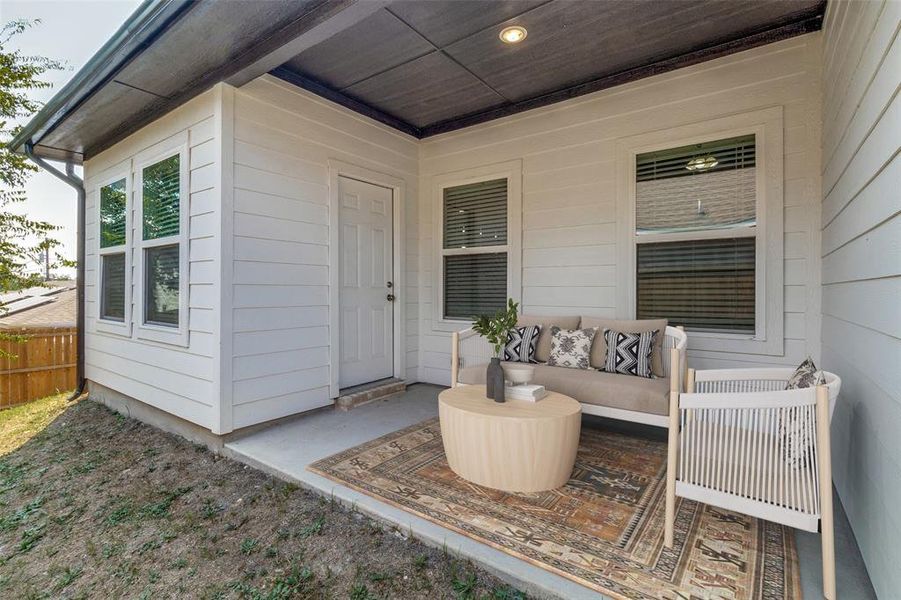 View of exterior entry with a patio