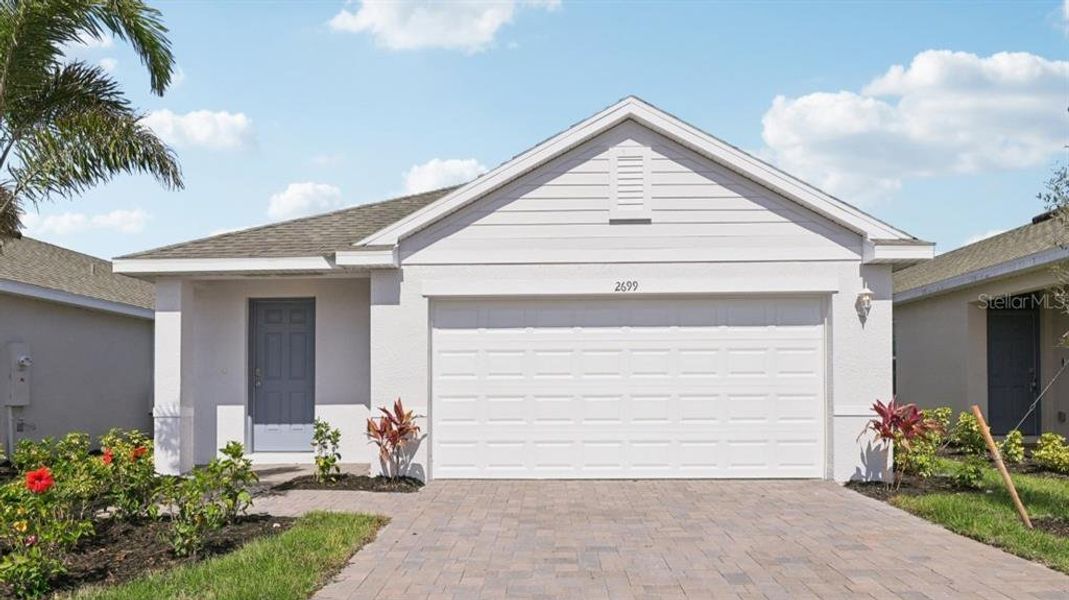 Front exterior of a new home in Driftwood Bay, Port Charlotte, FL, highlighting curb appeal (Image 10).