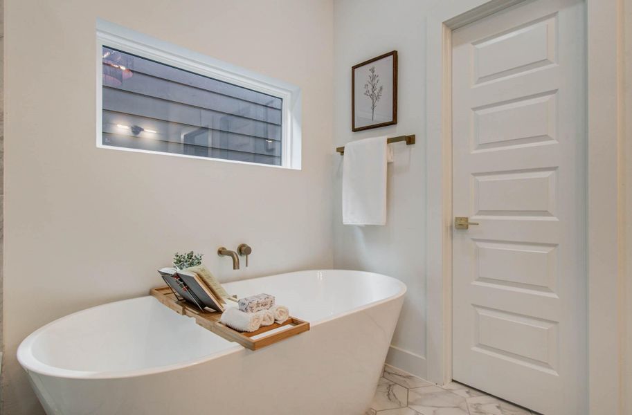 Soaking tub, ready for relaxing at the end of the day. Separate water closet.