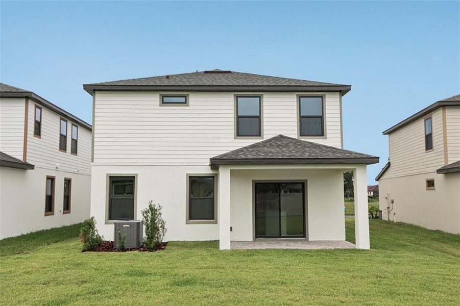 Front exterior of a new home in Grasslands West, Lakeland, FL, highlighting curb appeal (Image 2).