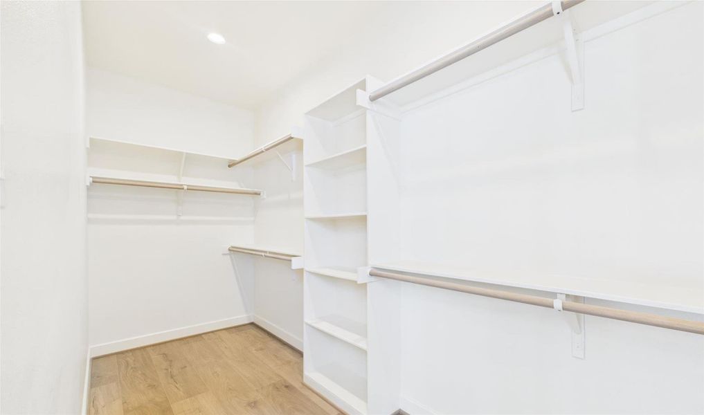 Explore the massive primary walk-in closet with built ins