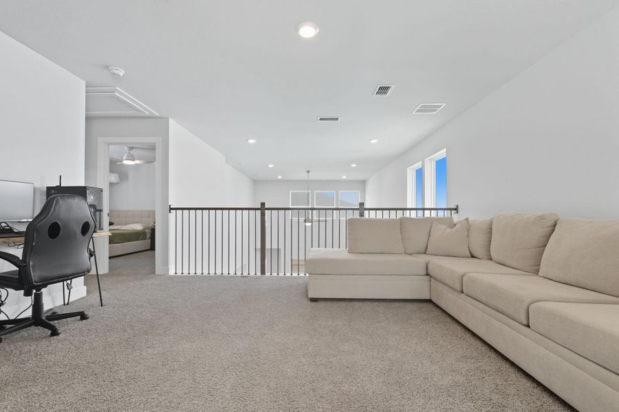 This oversized gamer room provides the perfect retreat for the upstairs bedrooms.