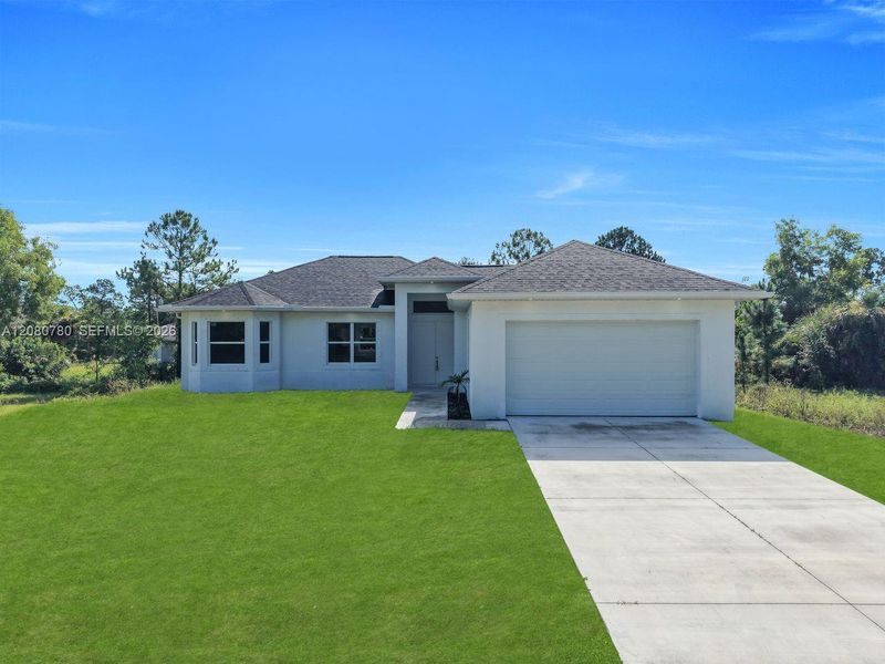 Front exterior of a new home in , Lehigh Acres, FL, highlighting curb appeal (Image 2). Front exterior of a new home in , Lehigh Acres, FL, highlighting curb appeal (Image 2).