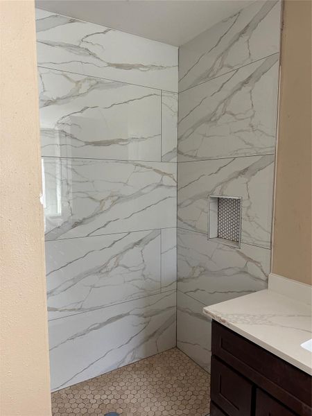 Enjoy a large walk-in shower that combines functionality with a sleek, modern design. Enjoy a large walk-in shower that combines functionality with a sleek, modern design.