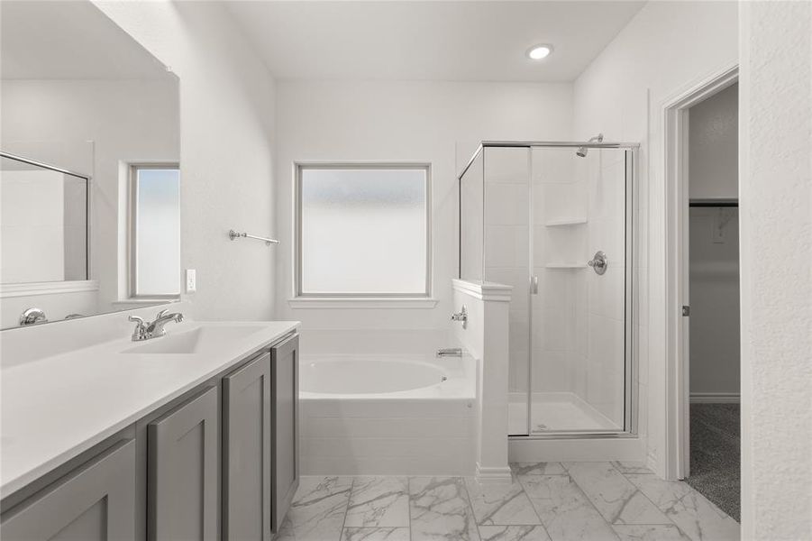 Bathroom featuring vanity and plus walk in shower