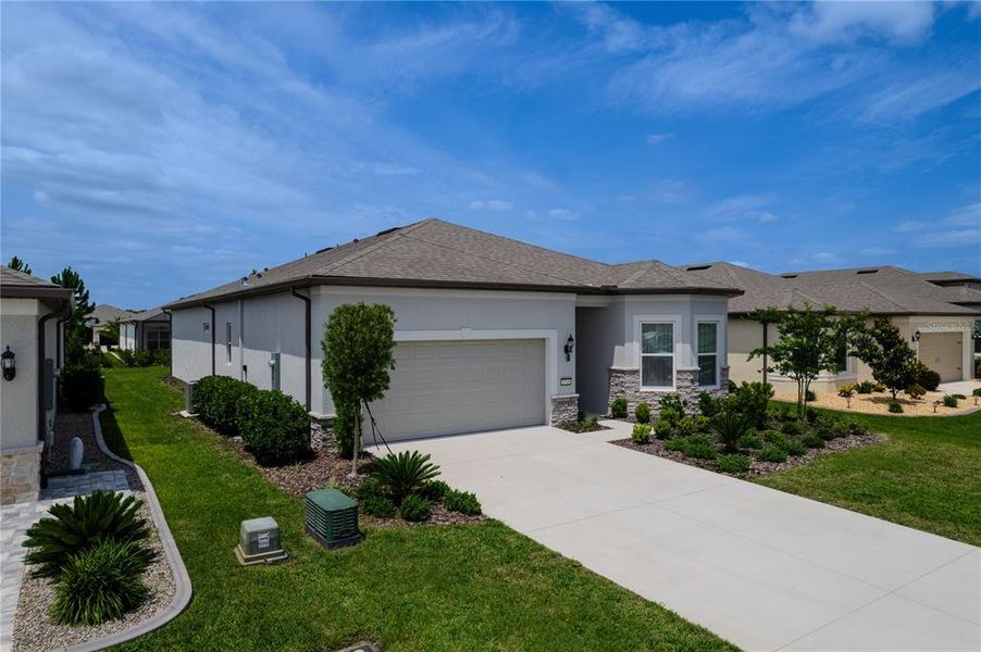 Front exterior of a new home in Del Webb Stone Creek, Ocala, FL, highlighting curb appeal (Image 26).