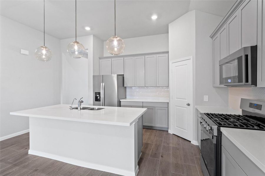 The kitchen island provides a convenient breakfast bar, perfect for casual dining and or long conversations.