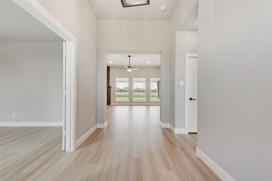 Hallway with light hardwood / wood-style flooring