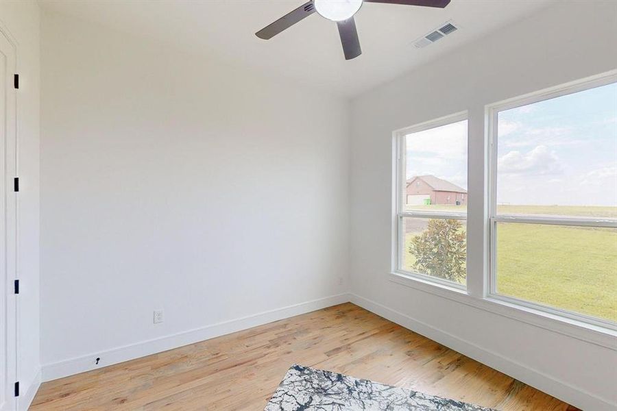 Empty room featuring ceiling fan and light hardwood / wood-style floors