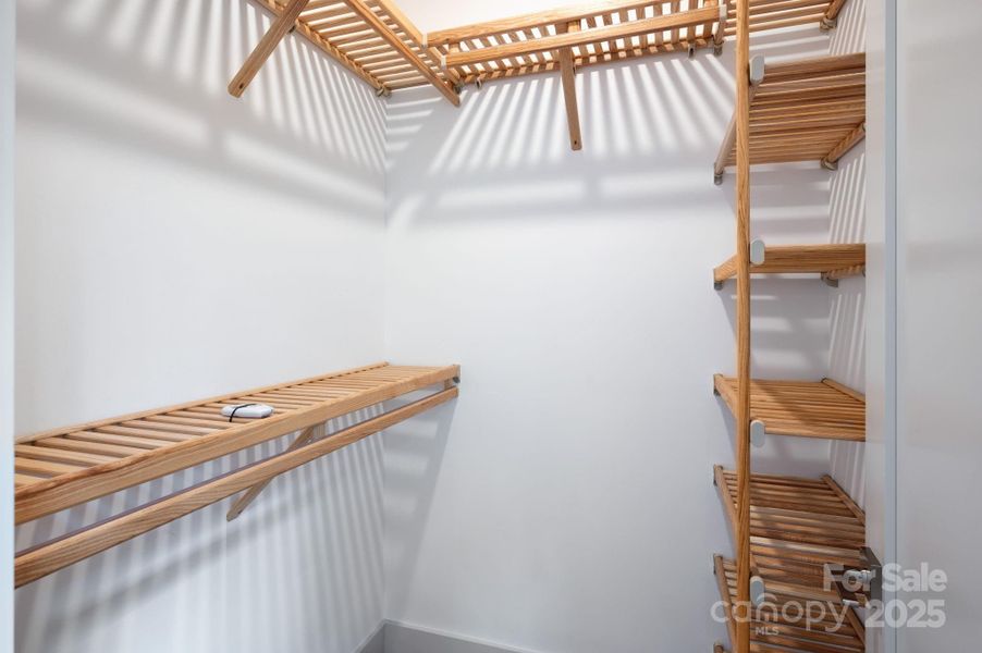 Primary Suite Walk-In Closet with Wood Shelving Primary Suite Walk-In Closet with Wood Shelving