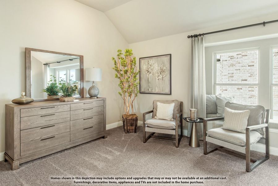 Bedroom sitting area with wood dresser, mirror, two accent chairs, and vaulted ceiling