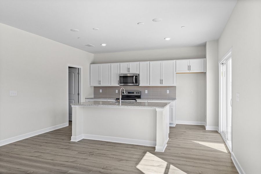A kitchen with white cabinets. A kitchen with white cabinets.