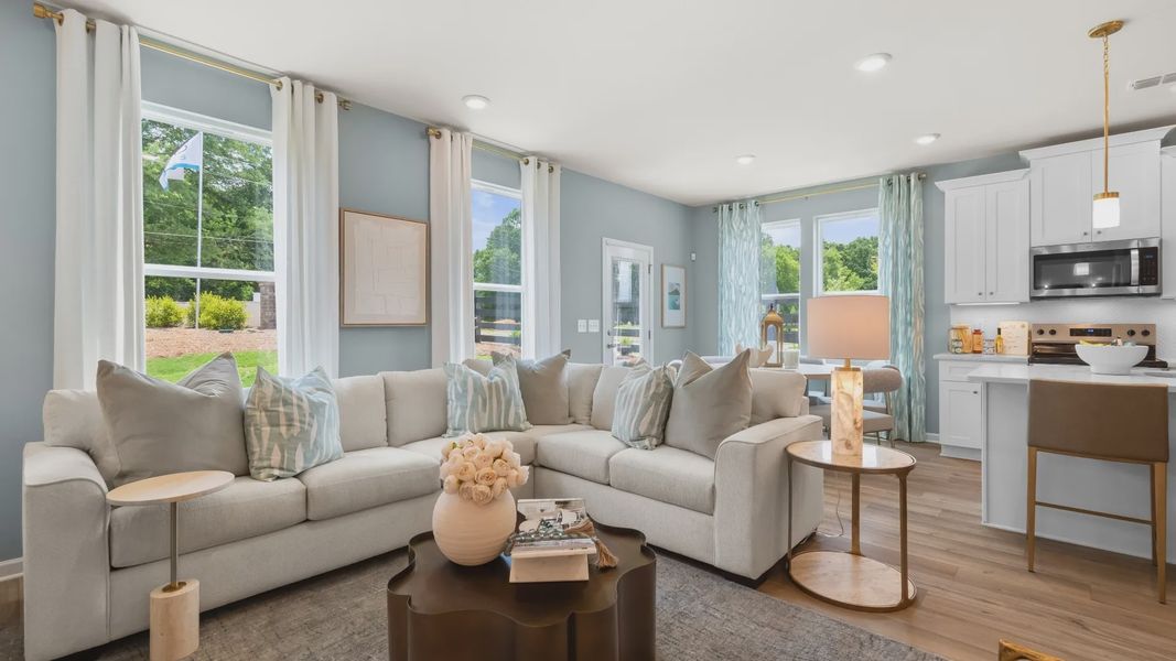 Open concept kitchen and family room in new construction townhome with seamless flow and natural light. Open concept kitchen and family room in new construction townhome with seamless flow and natural light.