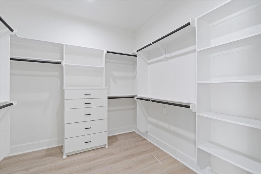 The primary suite features expansive walk-in closets with custom drawers and built-in LED lighting, combining luxury with practicality. Every item can be neatly organized and beautifully displayed, making daily routines effortless. This thoughtfully designed space adds both convenience and a touch of elegance to your personal retreat. The primary suite features expansive walk-in closets with custom drawers and built-in LED lighting, combining luxury with practicality. Every item can be neatly organized and beautifully displayed, making daily routines effortless. This thoughtfully designed space adds both convenience and a touch of elegance to your personal retreat.