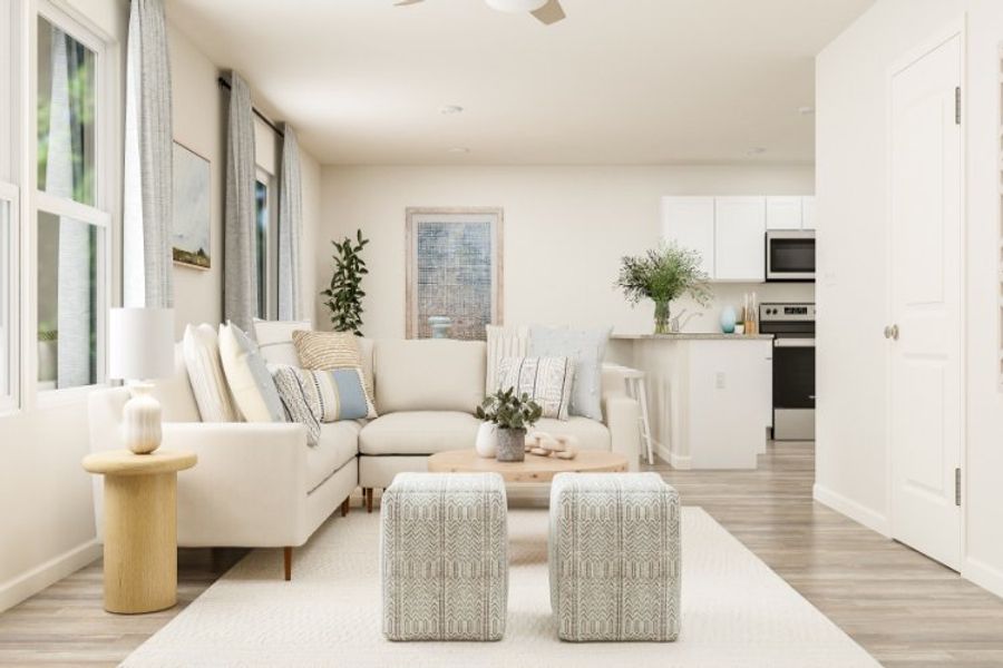 A living room with white furniture.
