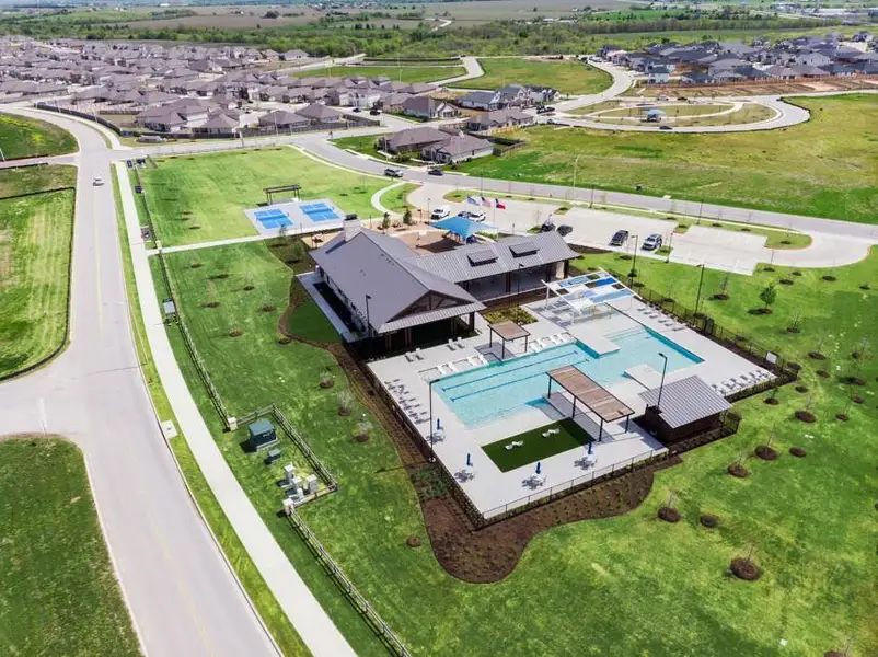 Aerial perspective of suburban area featuring a pool area Aerial perspective of suburban area featuring a pool area