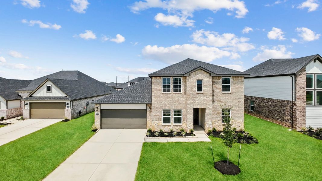 Front exterior of a new home in Tamarron, Fulshear, TX, highlighting curb appeal (Image 2).